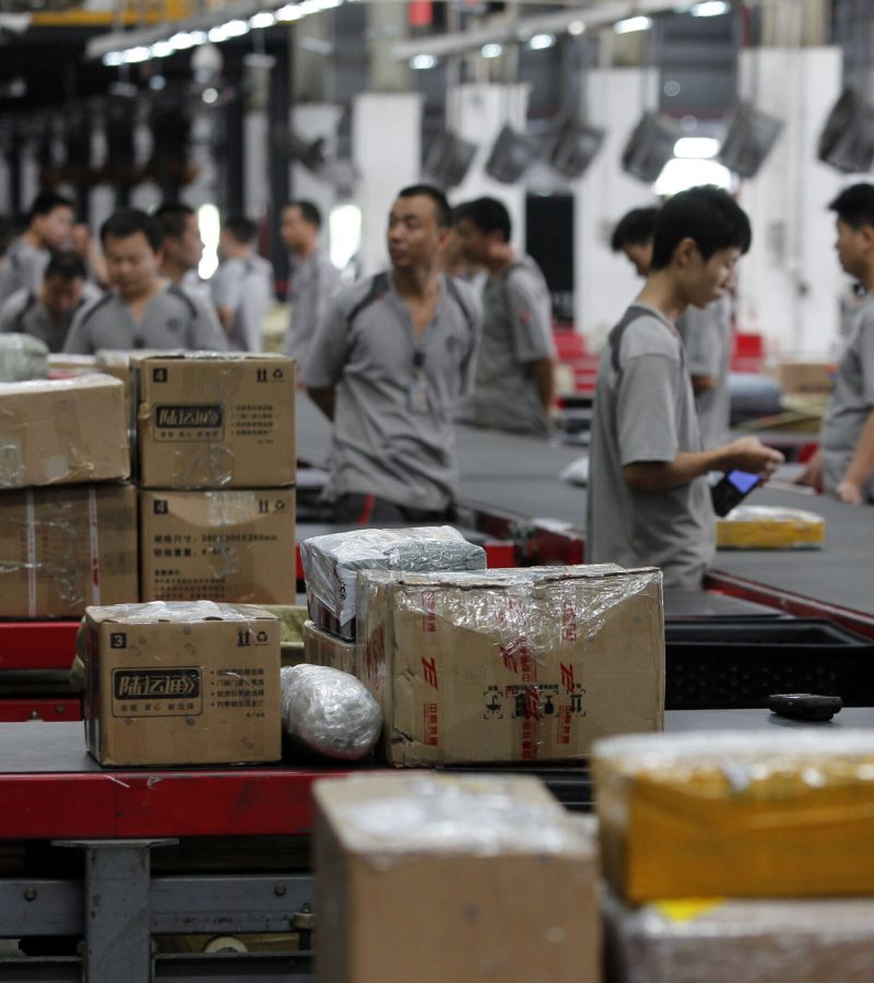 SHENZHEN, CHINA - NOVEMBER 11:  (CHINA OUT) Workers distribute packs at S.F. Express on November 11, 2013 in Shenzhen, China. Singles' Day has become China's Cyber Monday. The sales volume on Tmall.com and Taobao.com, the China's biggest online shopping sites of Chinese e-commerce giant Alibaba Group Holding, reached 19.1 billion yuan (3.13 billion U.S. dollars) at noon, equaling last year's overall daily sales.  (Photo by ChinaFotoPress/ChinaFotoPress via Getty Images)